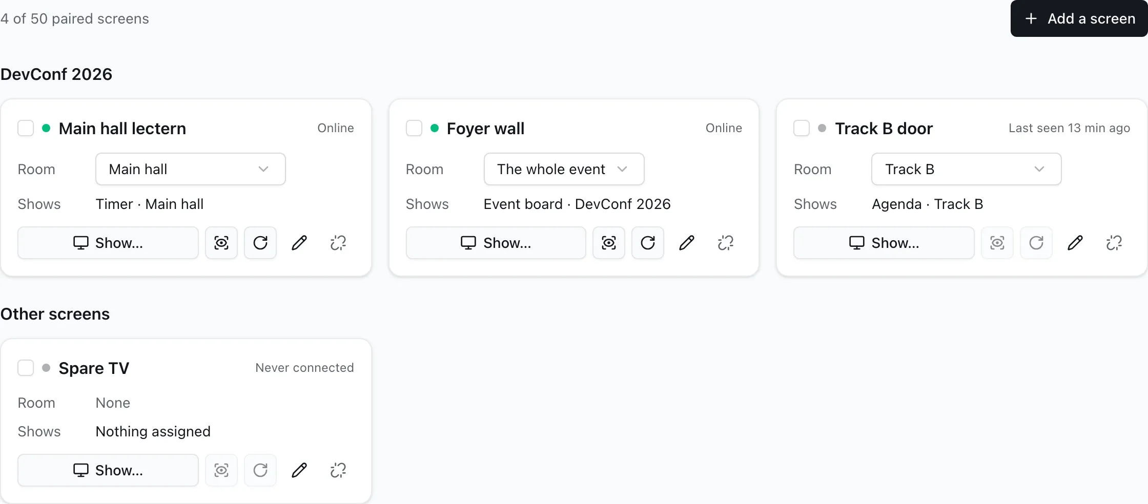 The Screens tab of DevConf 2026: the main hall lectern showing the main hall's Timer, the foyer wall showing the event board, and the Track B door showing Track B's agenda, each with its room, Show…, Identify, Reload, Rename, and Unpair; a spare TV with nothing assigned below.