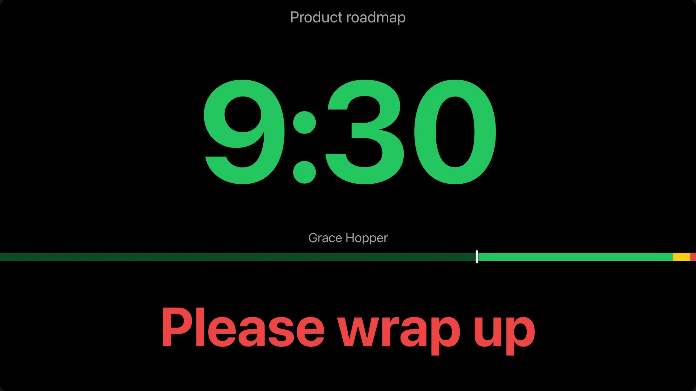 The main hall's screen at the same second: the Product roadmap countdown in green, Grace Hopper's name, the progress bar, and Please wrap up in red.